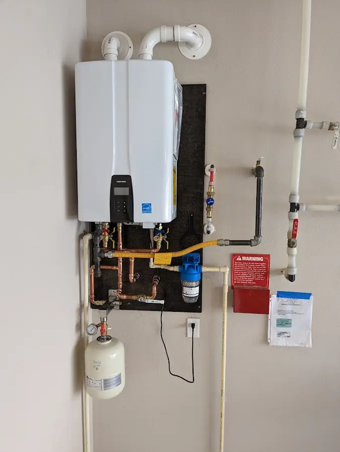 Professional plumber installing copper piping in a Piney Green home